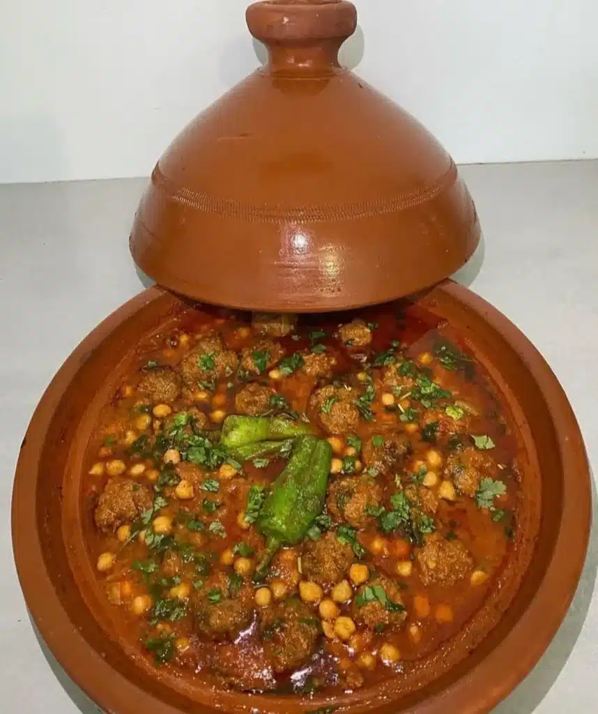 Authentic Algerian Tajine Mtewem with garlic meatballs, chickpeas, and almonds