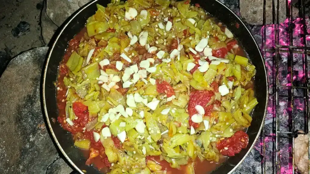 Cooking authentic Algerian Slata Mechwiya on hot coals